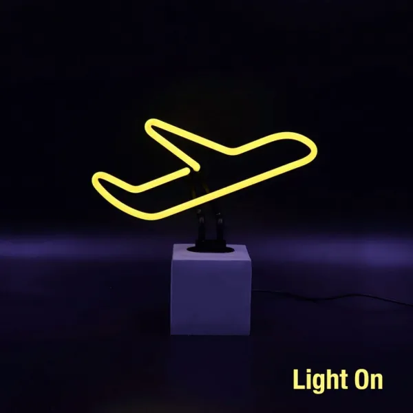 Yellow Neon Airplane Light on Concrete Base